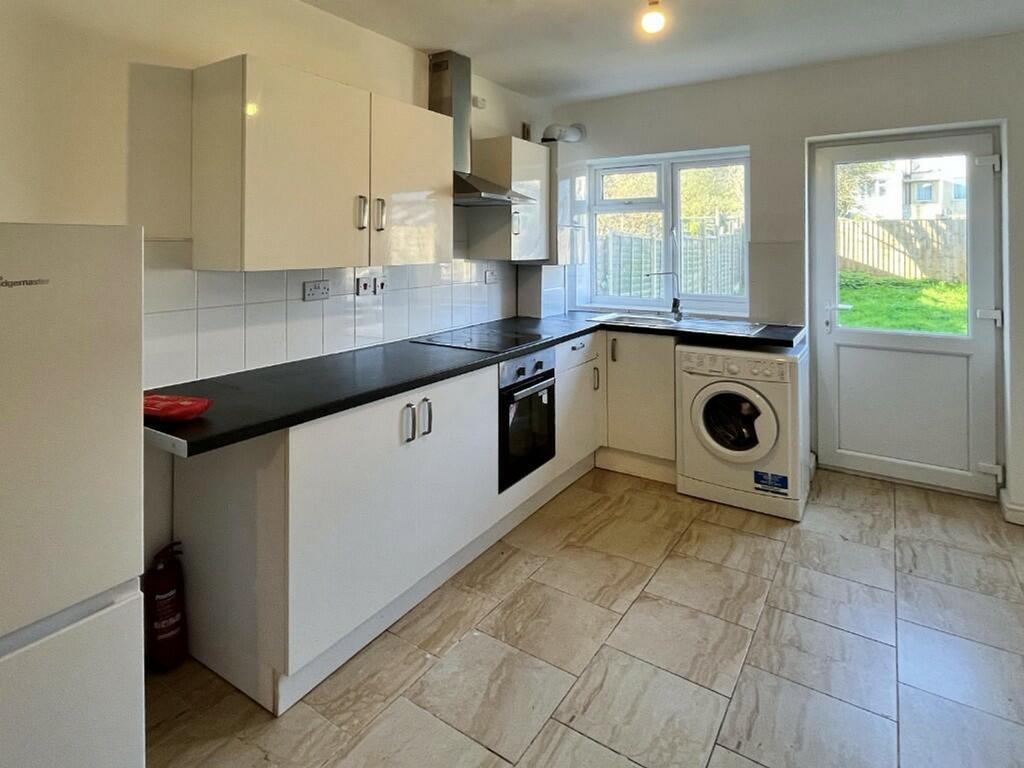 A bright and modern kitchen with ample space fo...