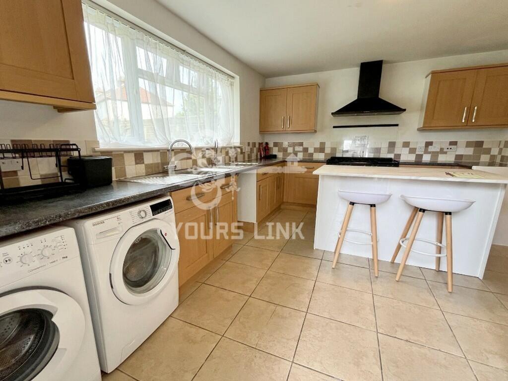 A bright and clean kitchenette with modern cabi...