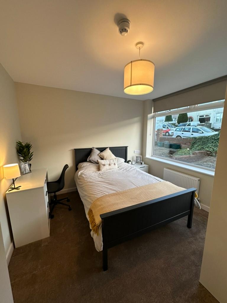 A bright and inviting double bedroom with moder...