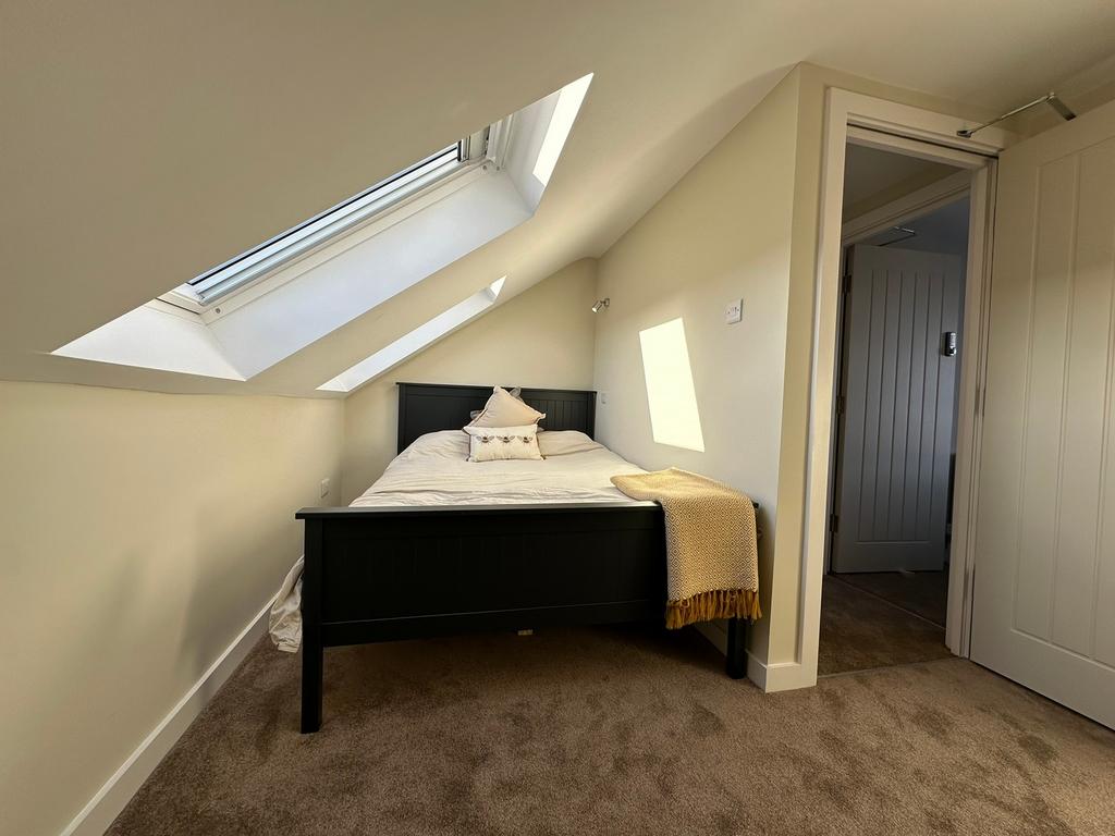 A bright and inviting double bedroom featuring ...