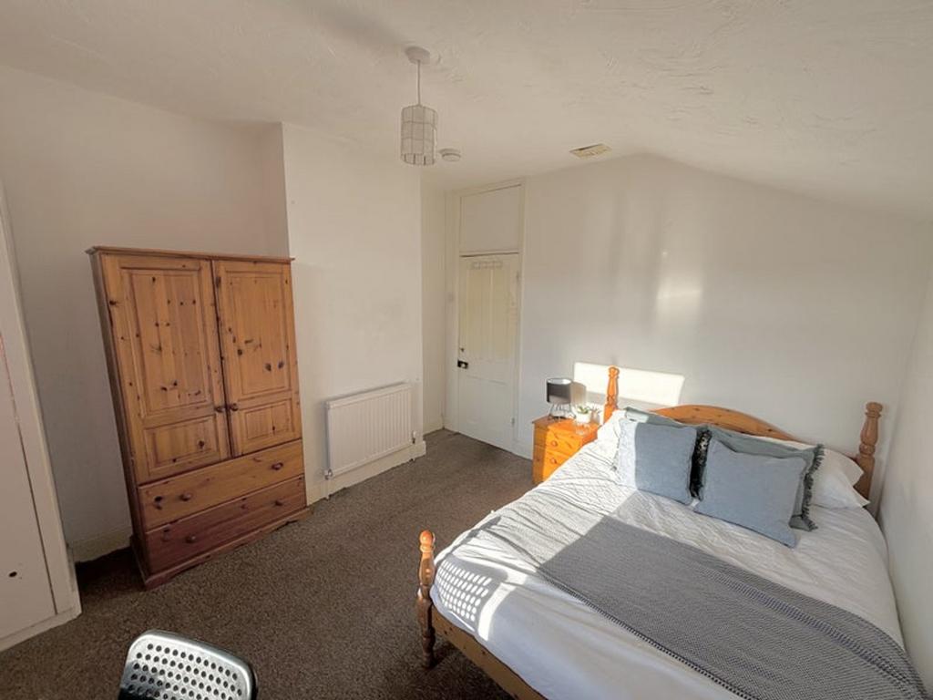 A bright and inviting double bedroom with ample...