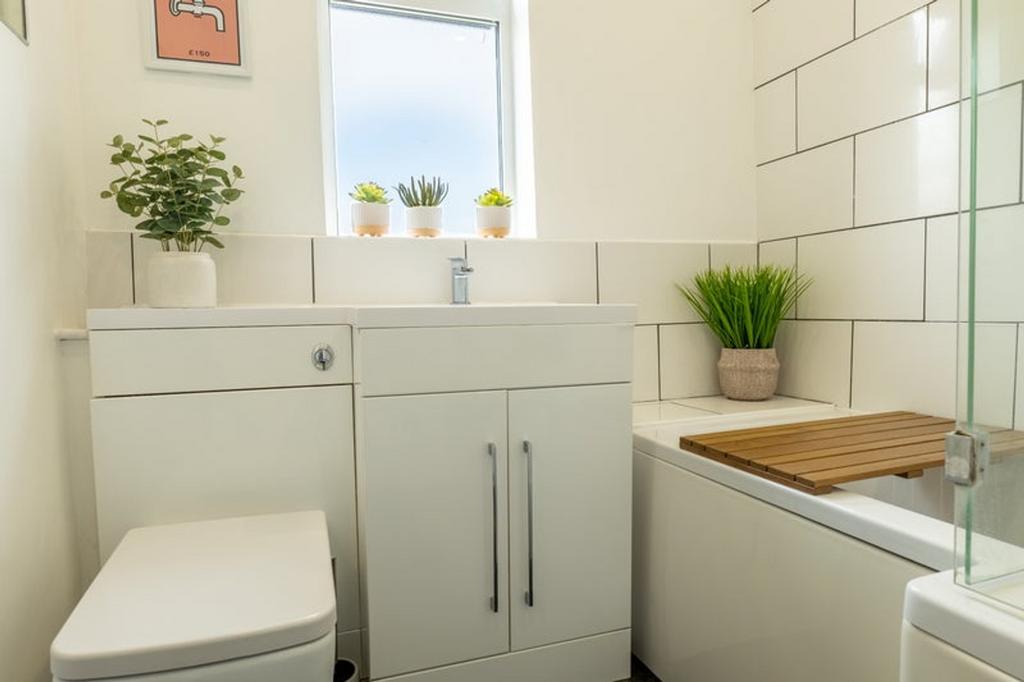 A bright and modern bathroom featuring a sleek ...