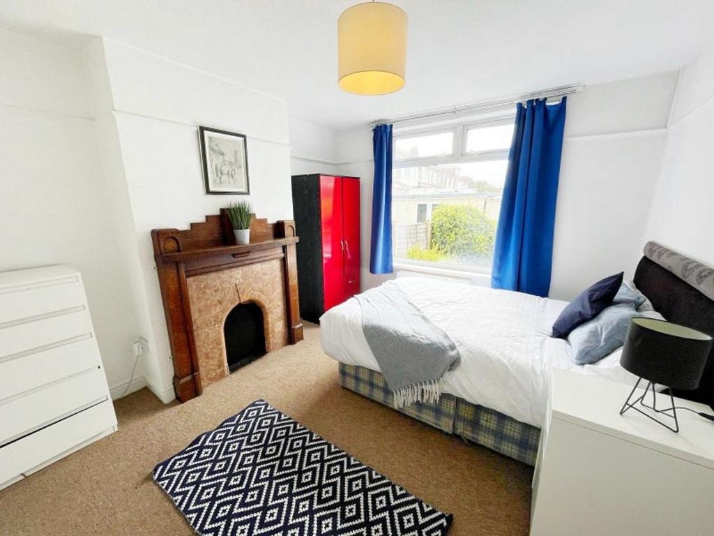 A spacious and bright double bedroom featuring ...