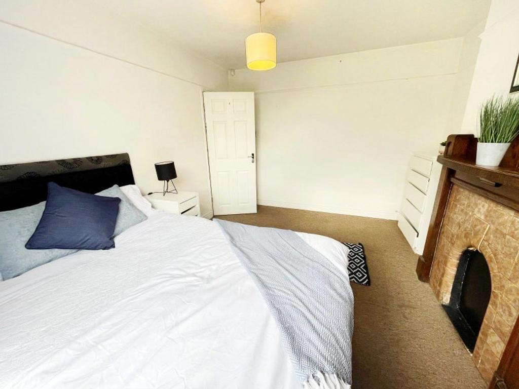 A spacious and inviting double bedroom featurin...