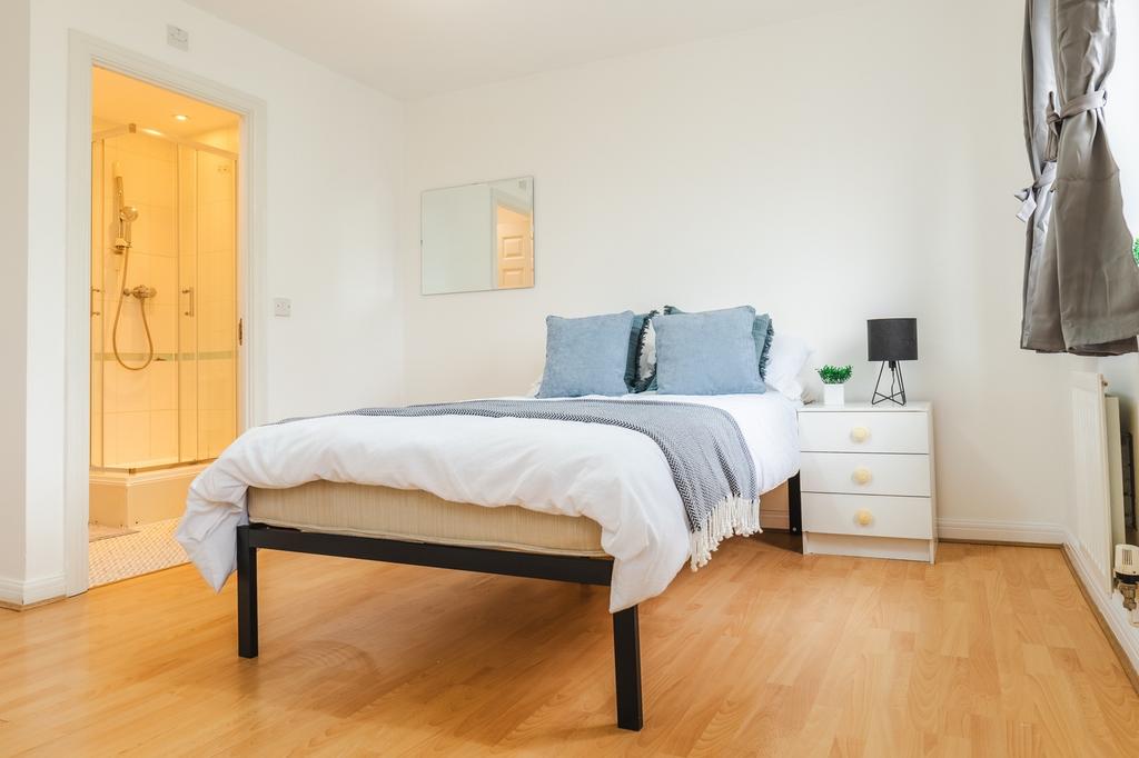 A bright and inviting double bedroom with moder...