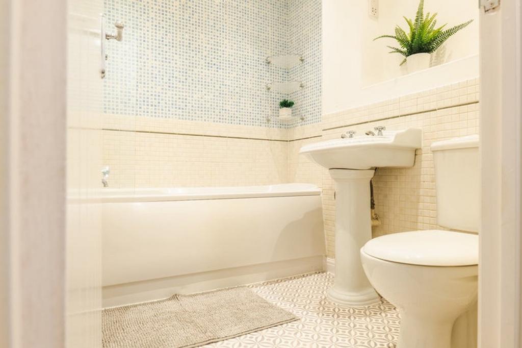 A bright and clean bathroom featuring a stylish...