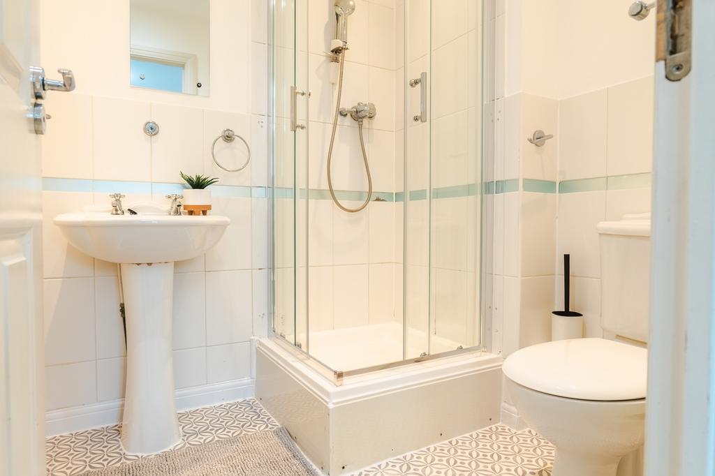 A bright and modern bathroom featuring a spacio...