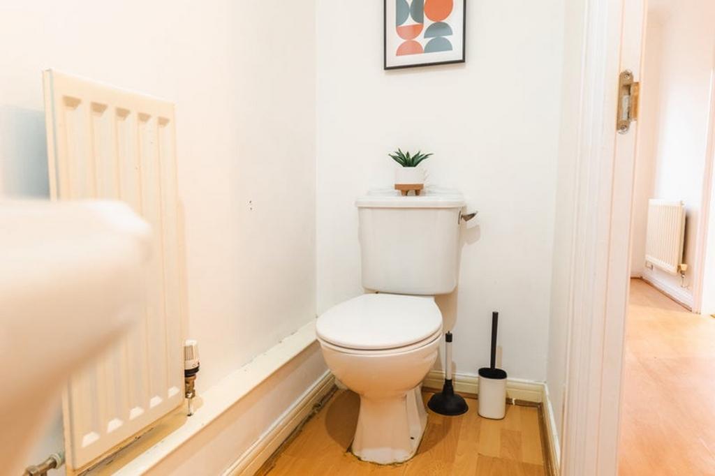 A clean and tidy single toilet area with modern...