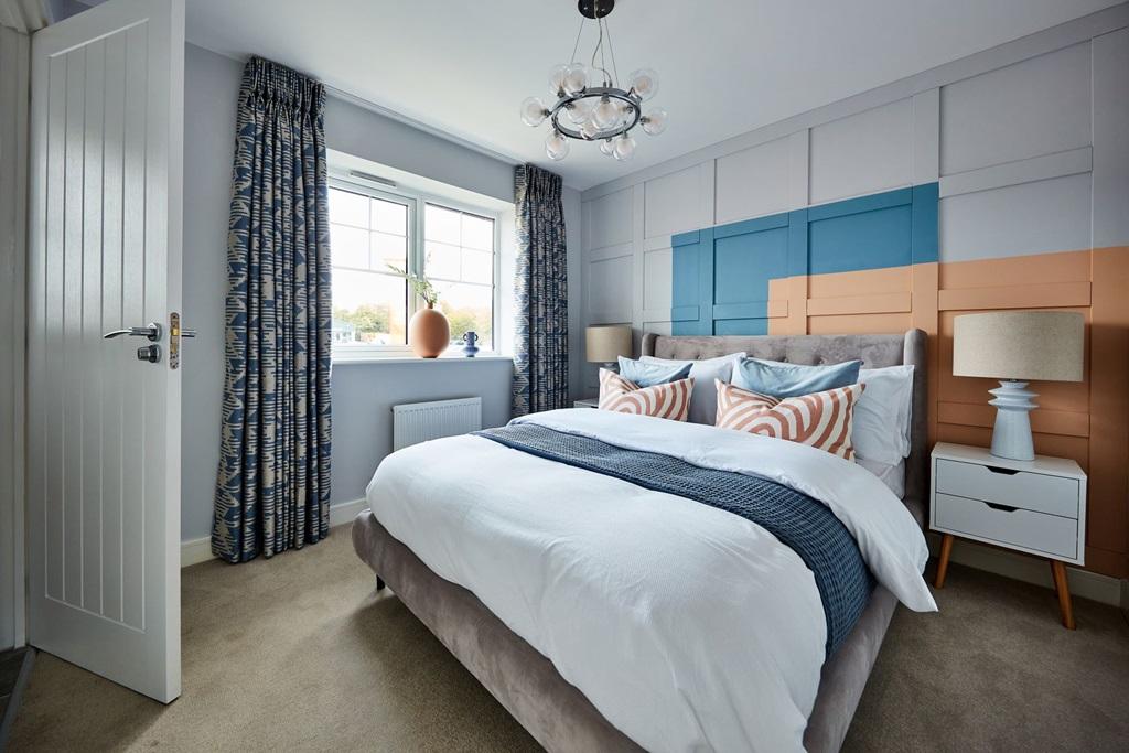 Large windows flood the bedroom with light