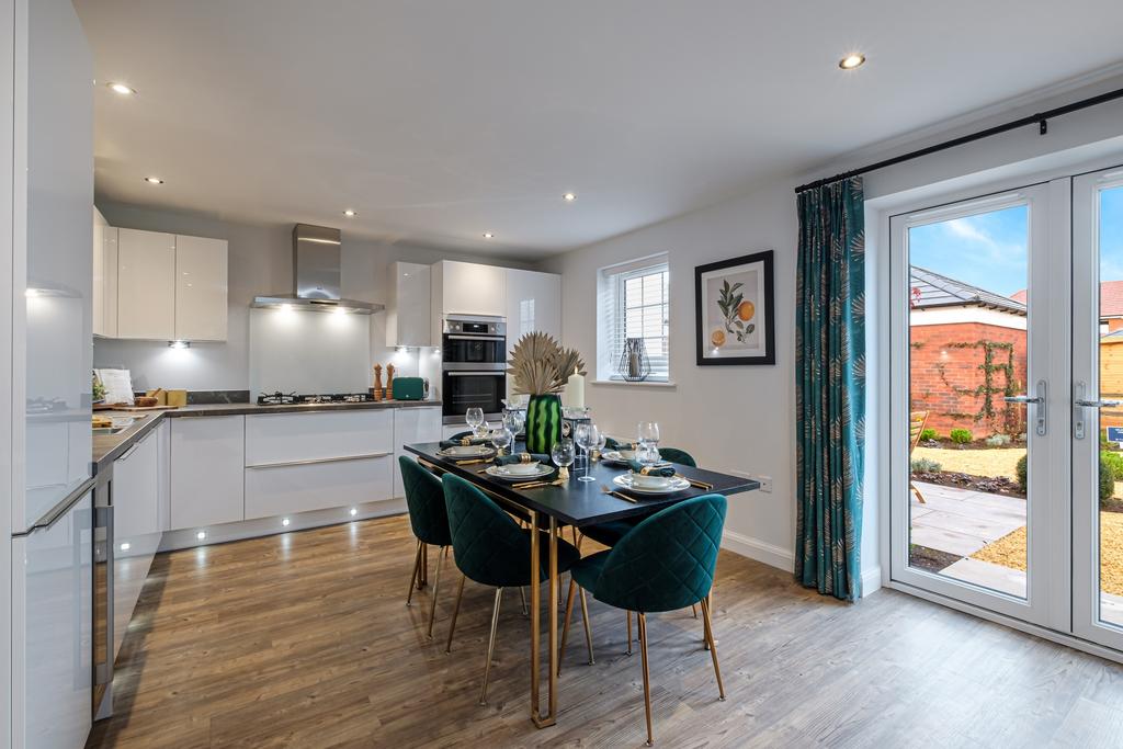 Large kitchen with blue chairs and French doors...