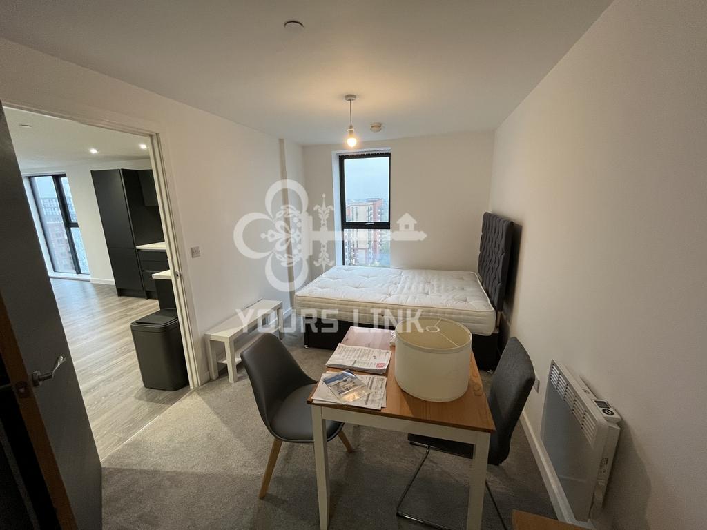 A spacious and bright double bedroom with a mod...