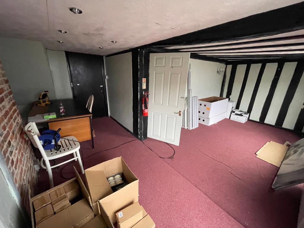 Vacant upper room with exposed beams