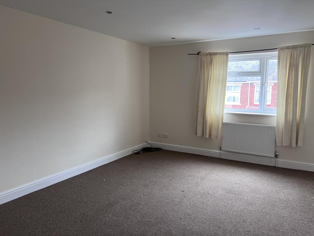 Bedroom one with magnolia walls and beige carpet