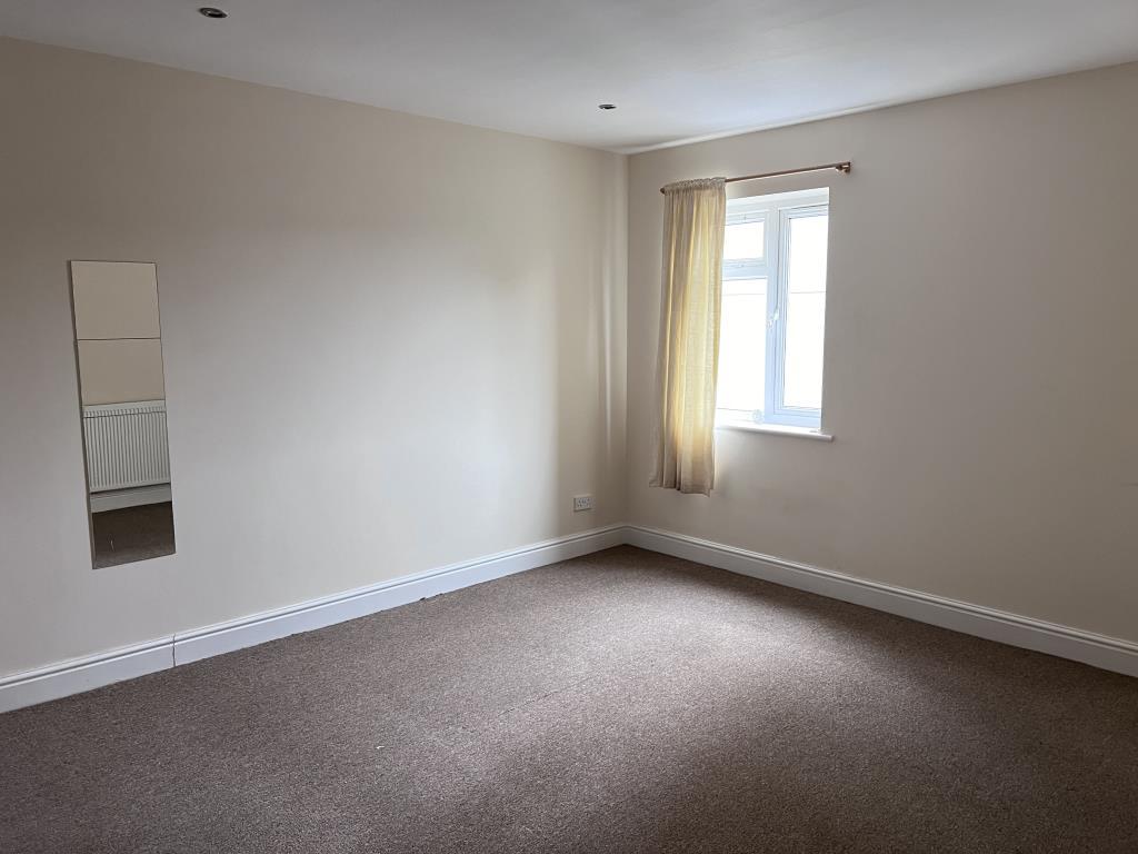 Bedroom two with smooth painted walls and neutral