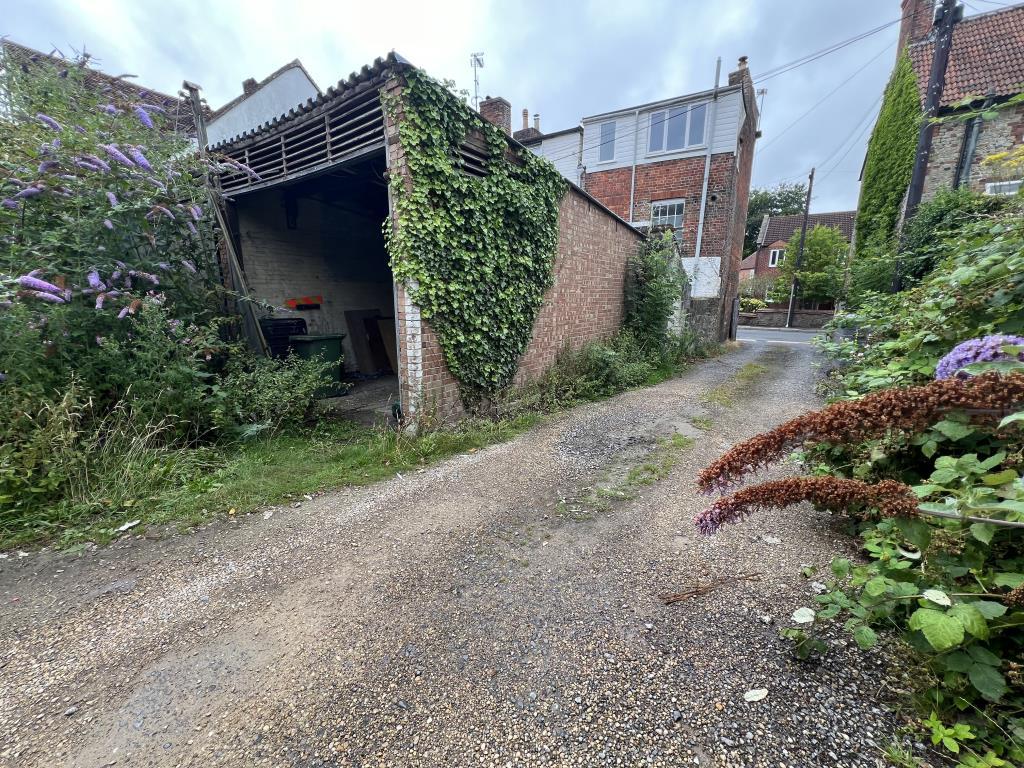 Site showing one garage and entrance to site