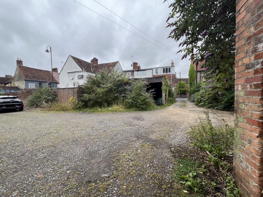 General view of the two garages with overgrown bus