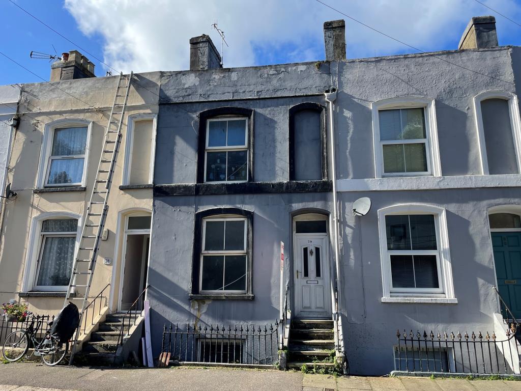 Mid terrace house with grey render