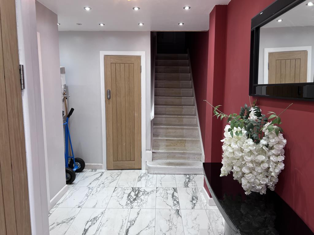 Communal hallway with painted walls and tile floor