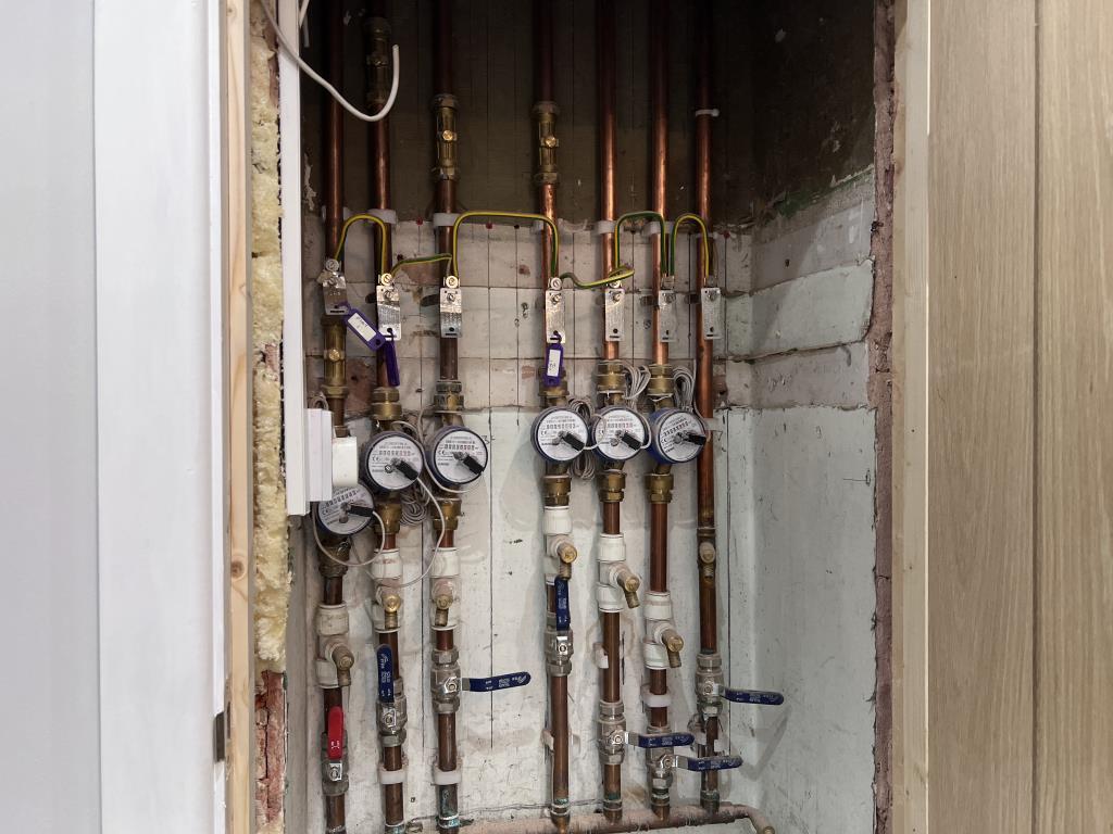 Communal cupboard showing split water supplies