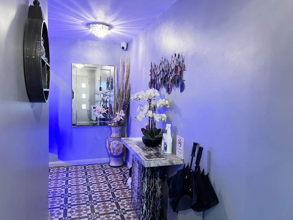 Communal hallway with painted walls and tile floor