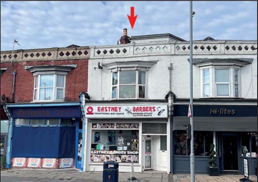 Front view of maisonette above barbers on main roa