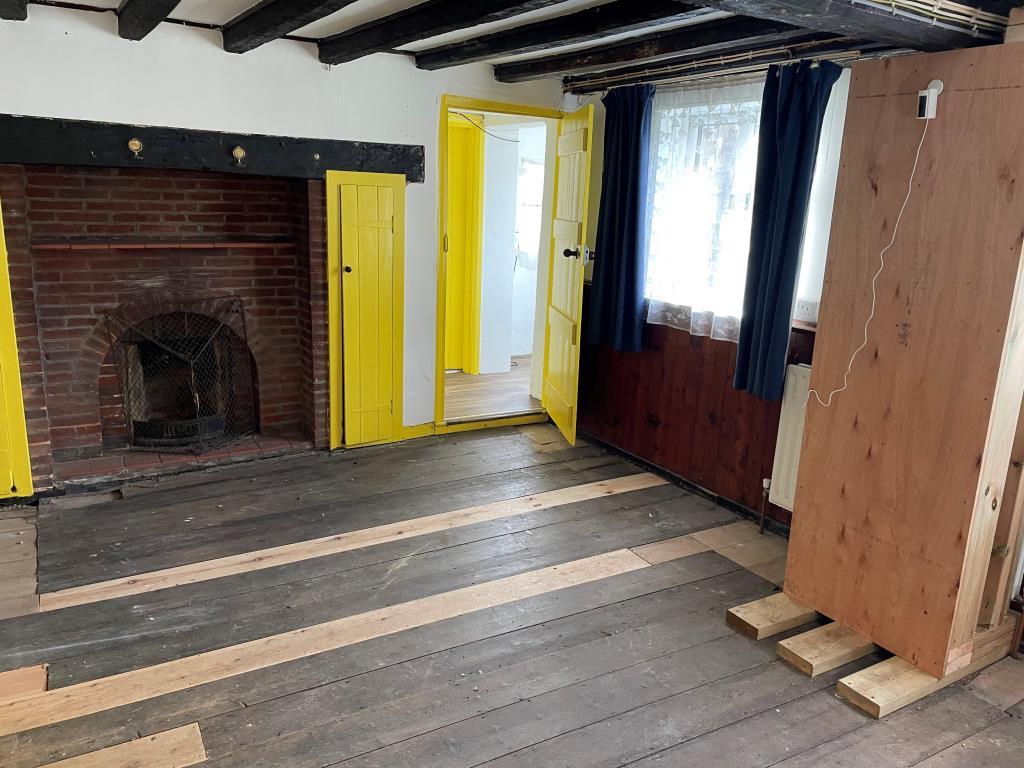 Living room with beams and fireplace