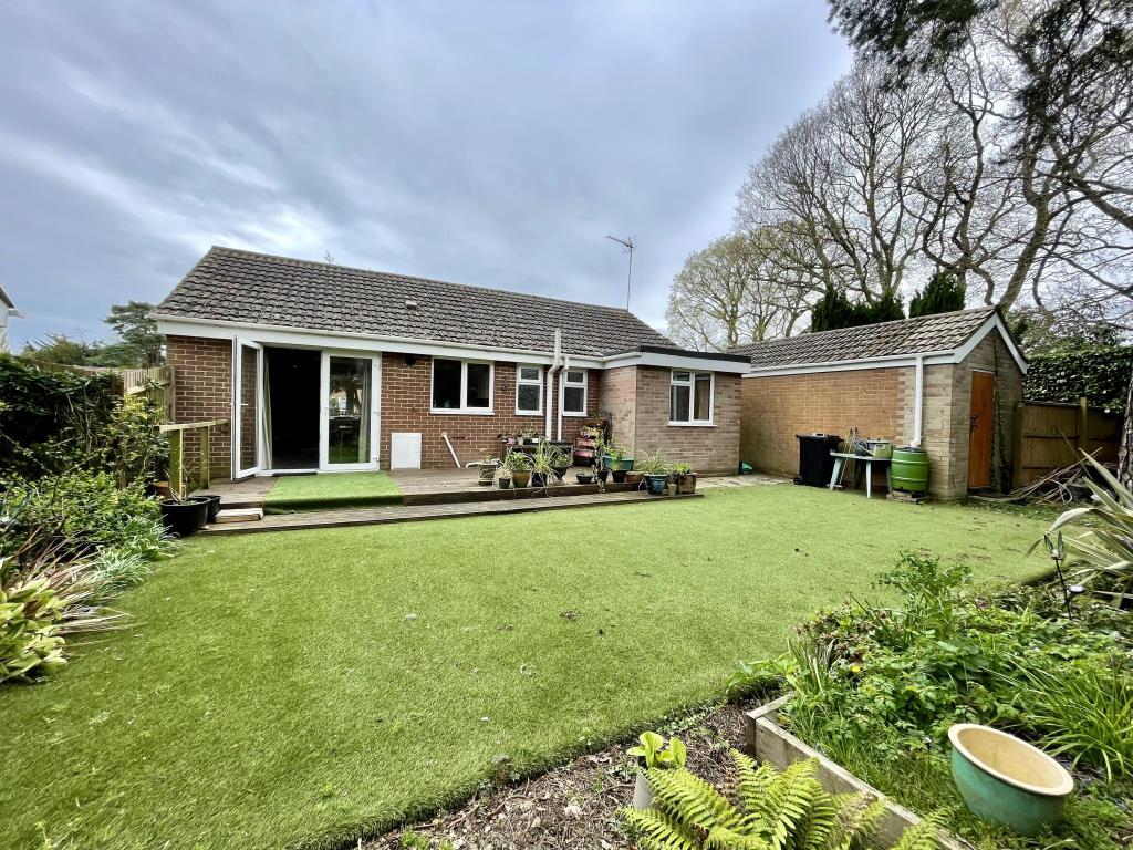 Rear view of bungalow and back garden