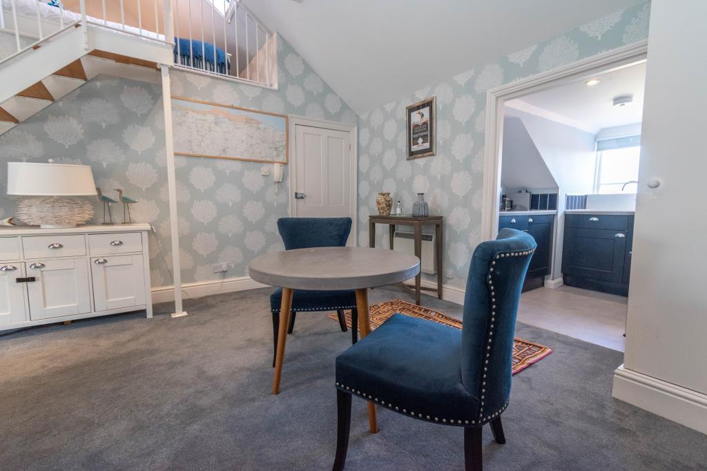 Living room with Bedroom above and door to kitchen