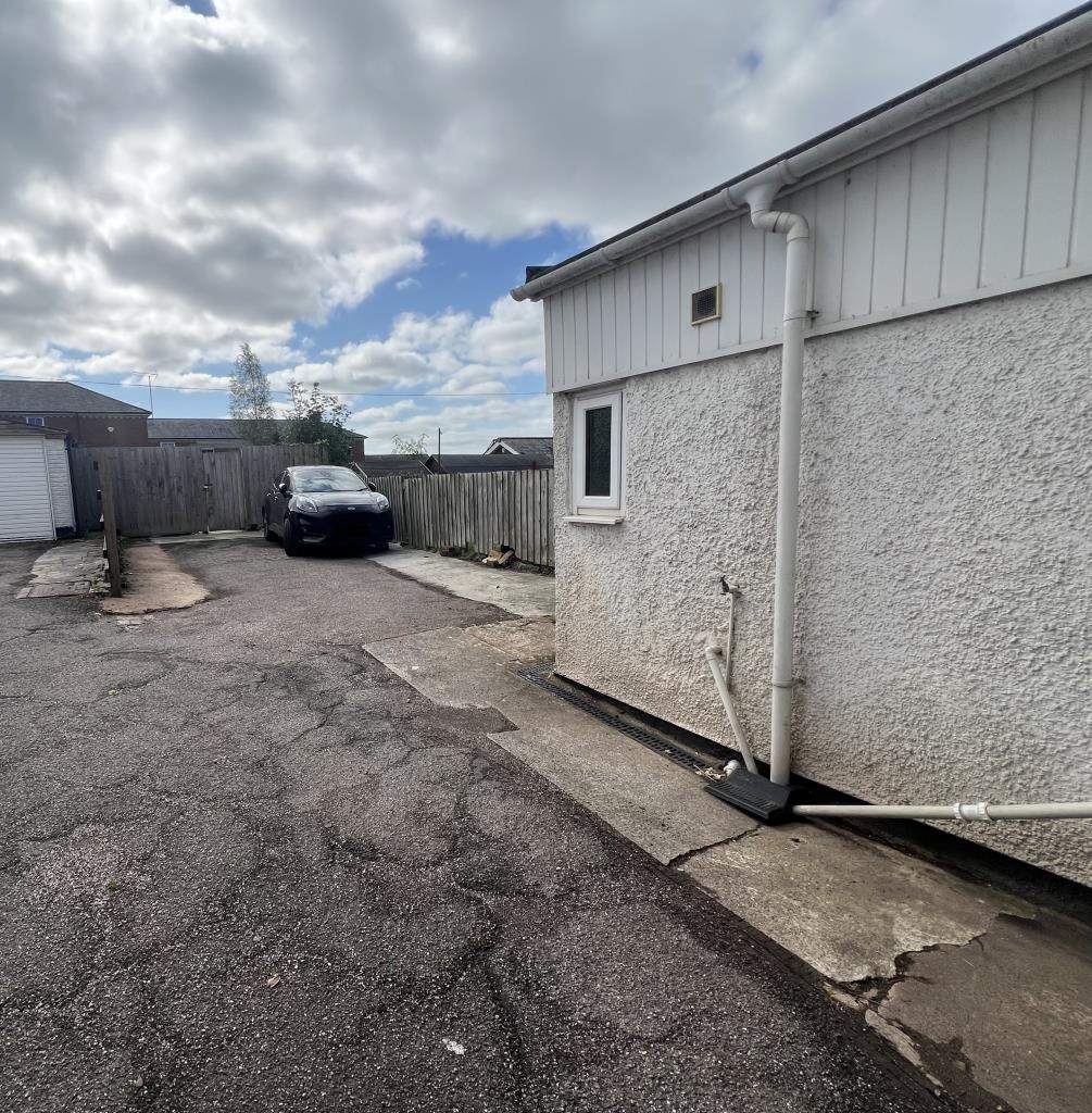 Rear parking area additional area behind fence