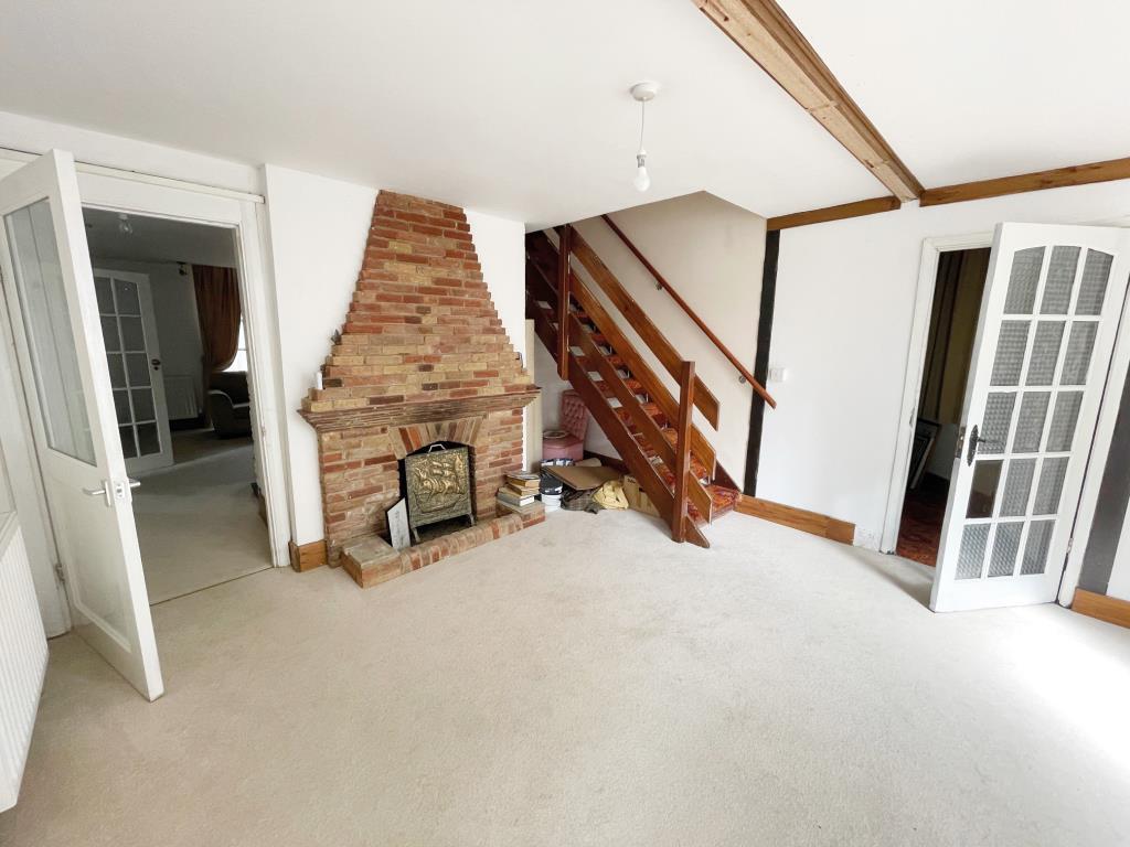 Reception room with fireplace and stair to first f