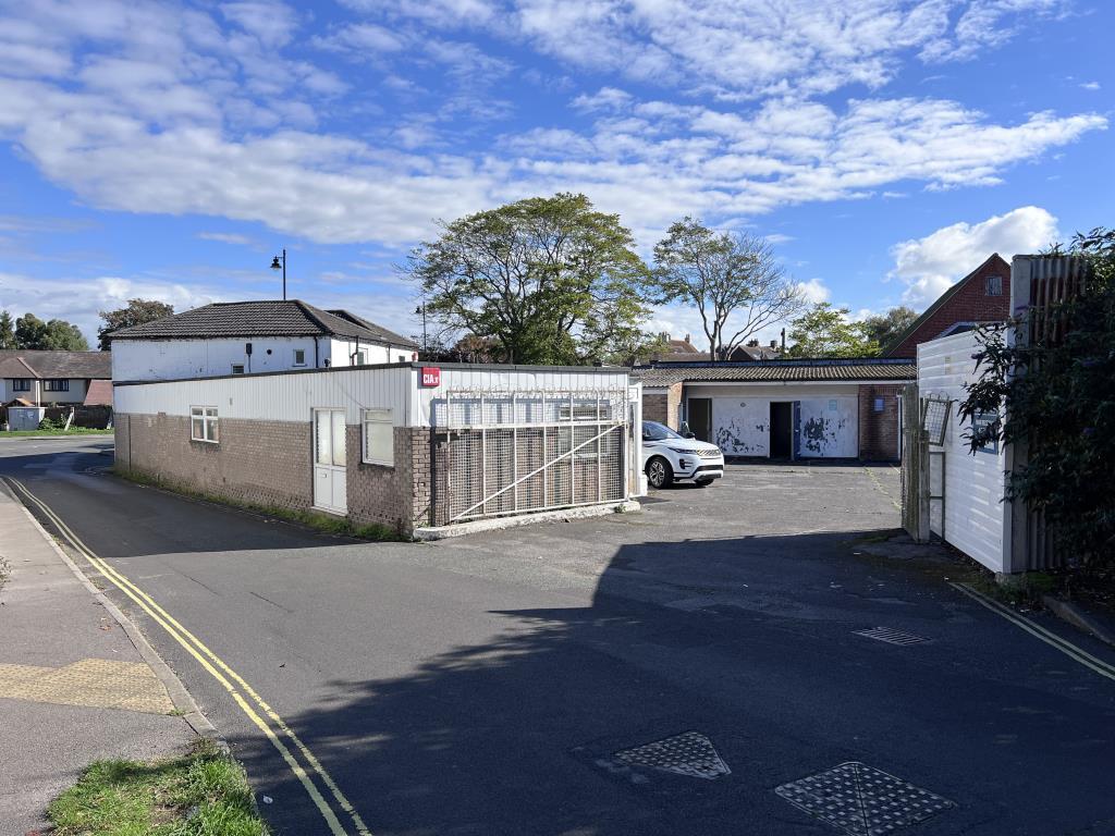 Rear entrance to car park with metal gates