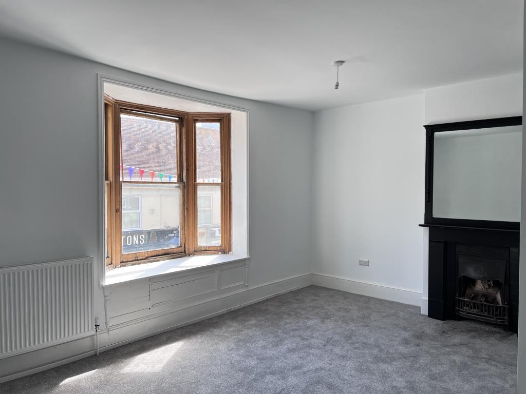 Living room with bay window over high street