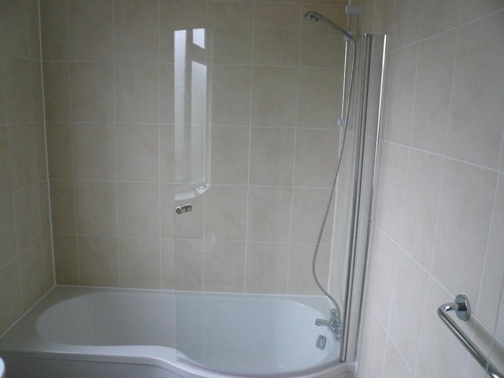 A spacious and clean bathroom featuring a moder...