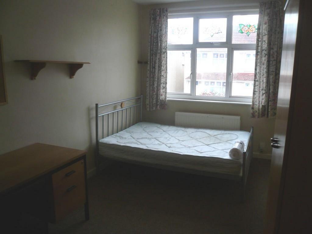 A bright and spacious double bedroom with a com...