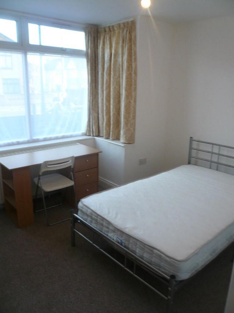 A bright and inviting double bedroom with ample...