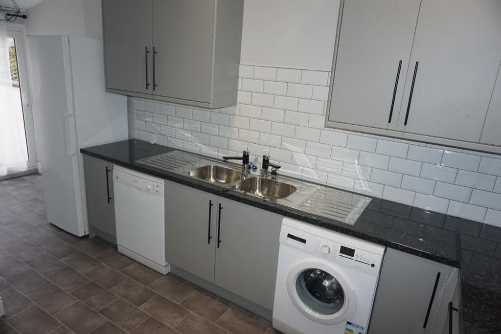 A modern and tidy kitchenette featuring sleek c...