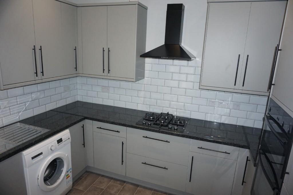 A modern and tidy kitchenette featuring sleek c...