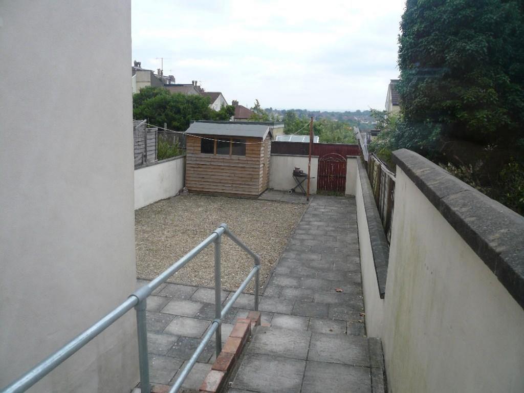 A spacious garden area featuring a gravel surfa...