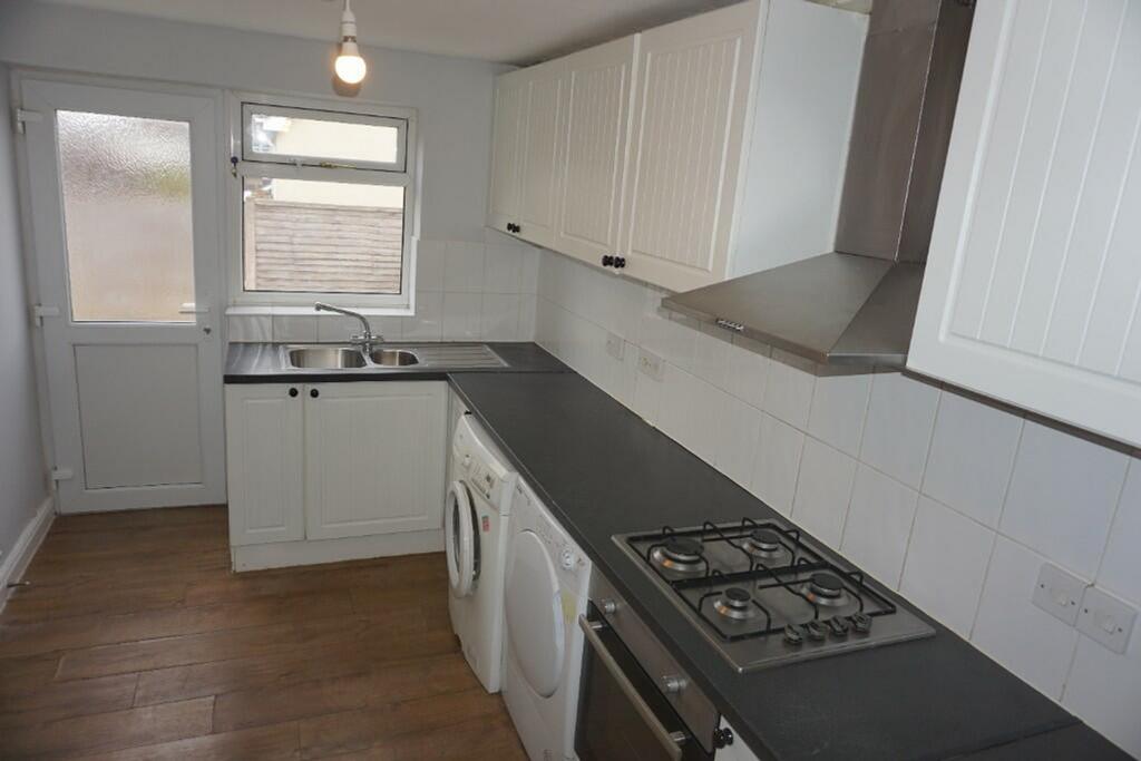 A bright and tidy kitchenette with modern appli...