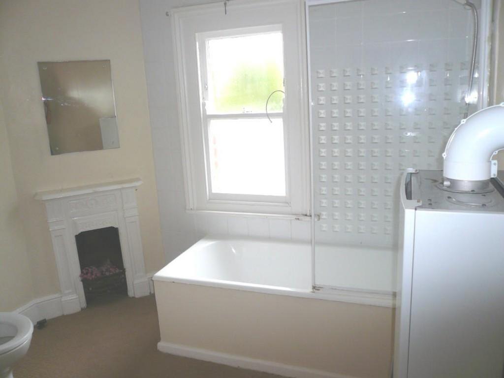 A spacious and bright large bathroom featuring ...