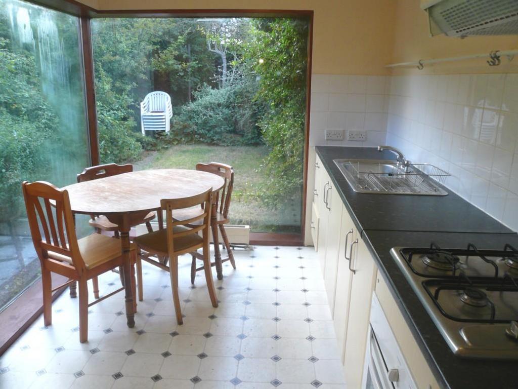 A bright and inviting kitchenette with a dining...