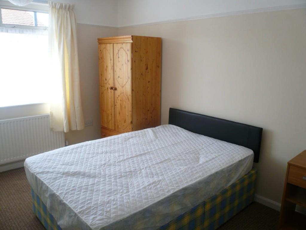 A bright and welcoming double bedroom with ampl...