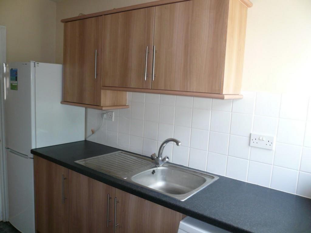 A tidy and functional kitchenette featuring amp...