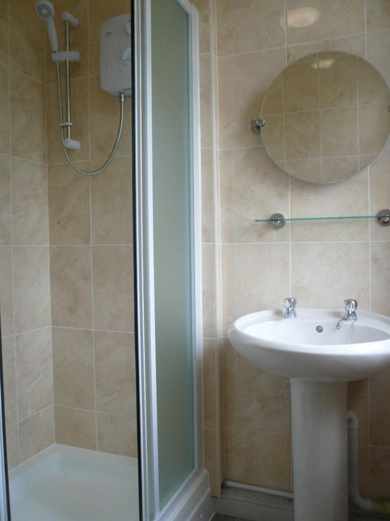 A clean and tidy bathroom featuring a shower an...