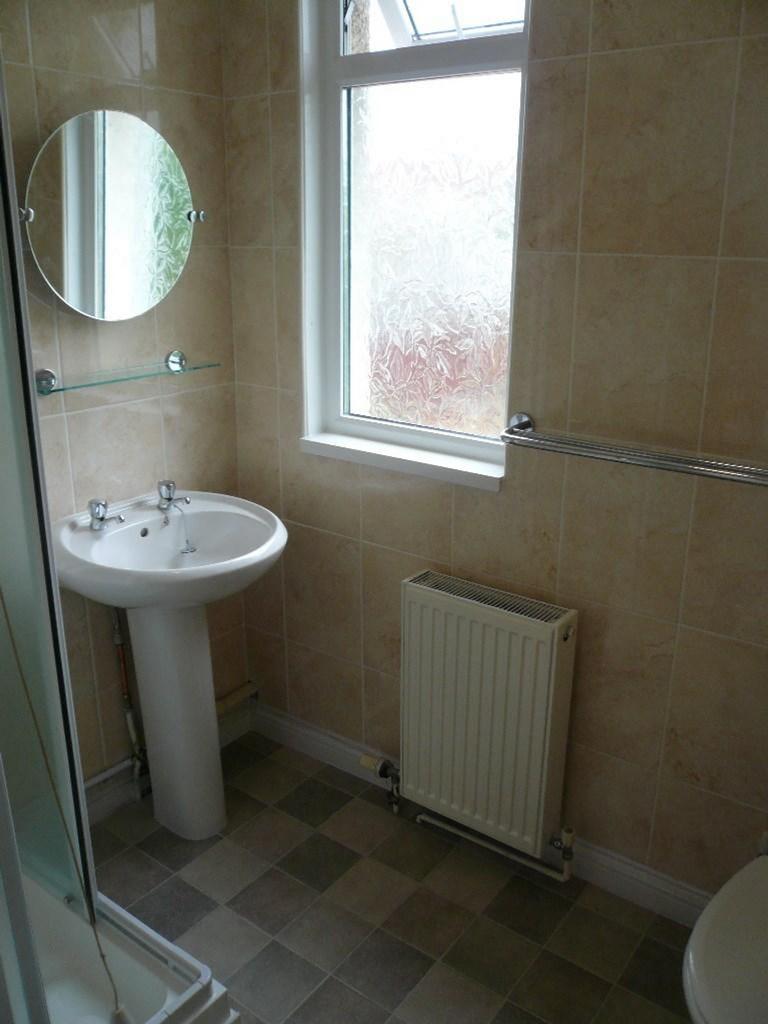 A tidy and well maintained bathroom featuring a...