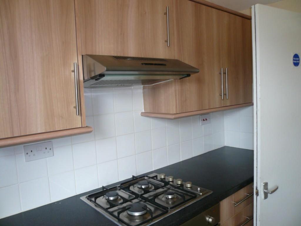 A tidy and modern kitchenette featuring ample s...