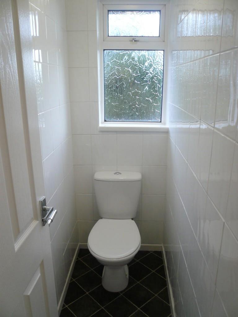 A clean and functional single toilet with good ...