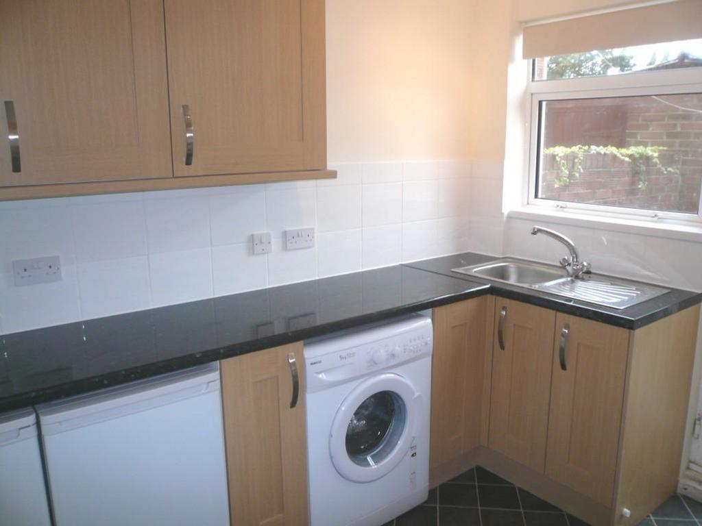 A bright and tidy kitchenette featuring modern ...