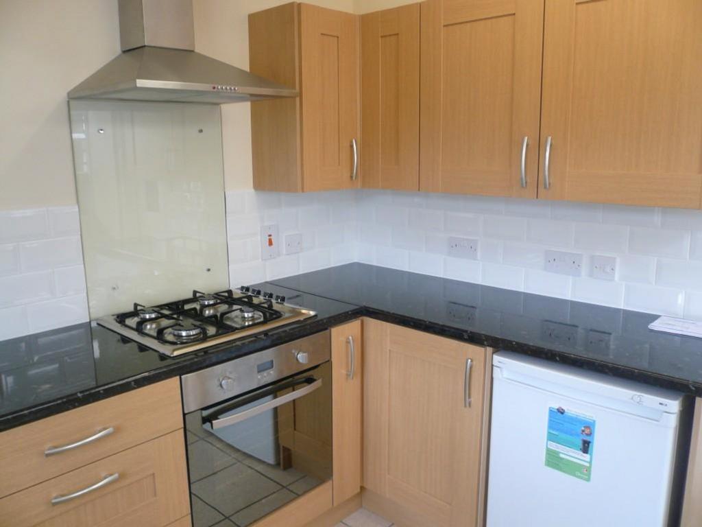 A modern and tidy kitchenette with sleek finish...