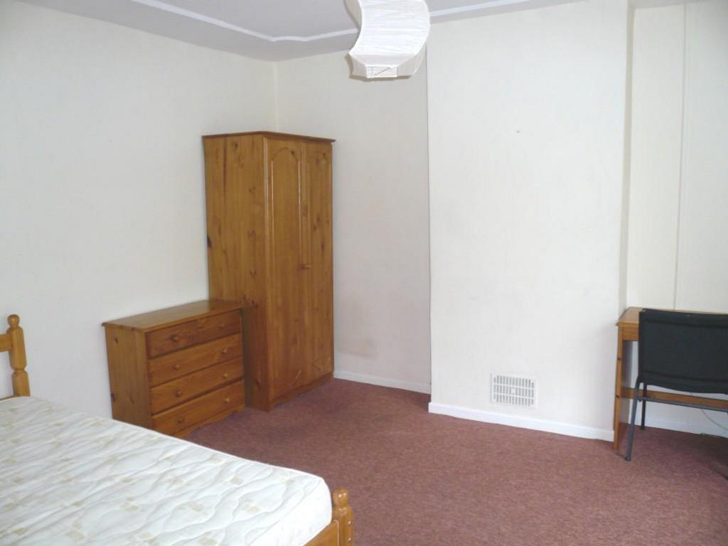 A spacious and tidy double bedroom with ample s...